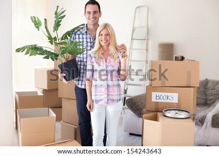 Young couple standing in new home