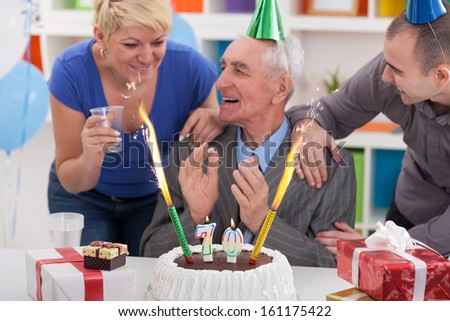Senior man celebrating birthday with his family
