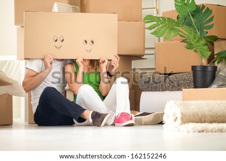 Couple with empty boxes on heads with smiley on it