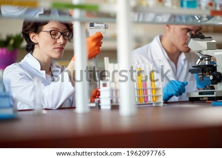 Similar – Foto Bild Nachwuchswissenschaftler pipettieren im Labor für Biowissenschaften.