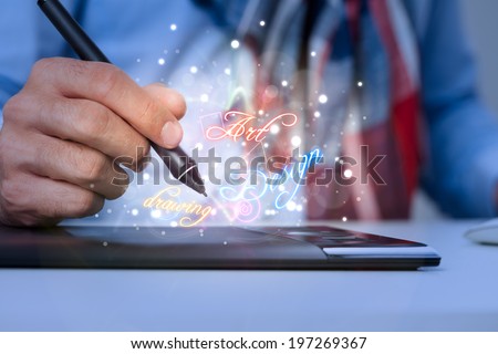 Hand of graphic designer on graphics tablet