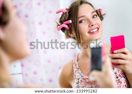 Teen girl making self in bathroom  front mirror