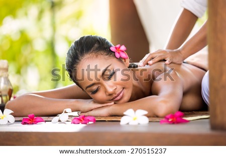 Woman having relaxing Asian massage in spa salon