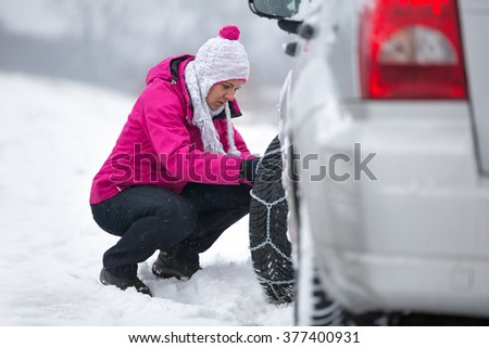Similar – Image, Stock Photo Woman putting security snow chain in tire wheel of car