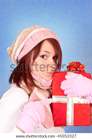 funny winter girl pointing to her gift