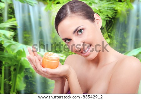 Young beautiful woman holding  cream for body