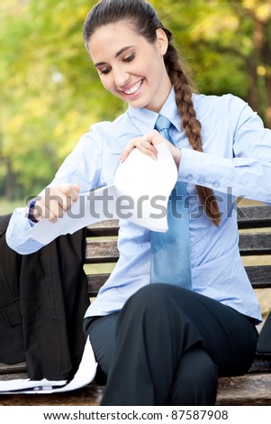 smiling business woman terminates the contract ripping, outdoor
