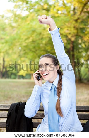 businesswoman happy for good news with raised arm