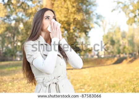 young woman have flu, autumn park