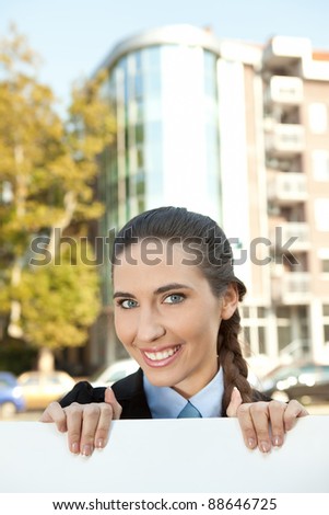 business woman holding blank paper for advertisement