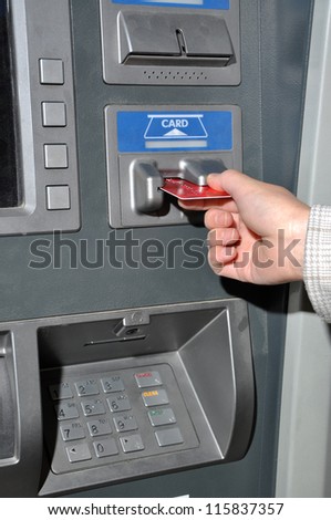 Woman insert card to withdraw money