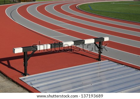 Track and athlete hurdling field
