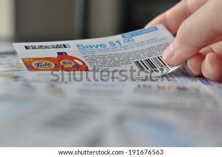 COQUITLAM, BC, CANADA - MAY 8 -  Coquitlam BC Canada - May 8, 2014 : Holding coupon for saving item. All coupons for Canadian store, they are issued by manufacturers of consumer packaged goods Canada.