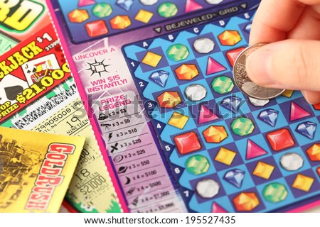 COQUITLAM, BC, CANADA - MAY 25  - May 25, 2014 : Scratching lottery tickets. The British Columbia Lottery Corporation has provided government sanctioned lottery games in British Columbia since 1985.