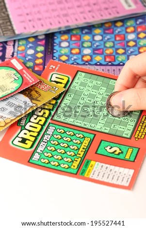 COQUITLAM, BC, CANADA - MAY 25, 2014 : Scratching lottery tickets. The British Columbia Lottery Corporation has provided government sanctioned lottery games in British Columbia since 1985.