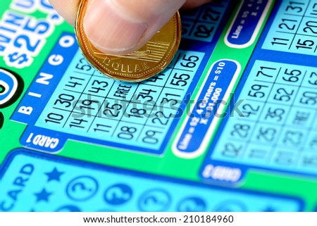 Coquitlam BC Canada - June 15, 2014 : Woman scratching lottery ticket called Bingo. It\'s published by BC Lottery Corporation has provided government sanctioned lottery games.