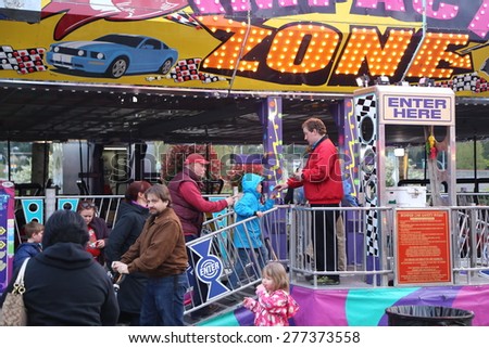 Coquitlam, BC, Canada - April 09, 2015 : People line up for entering bumper cars section at the West Coast Amusements Carnival