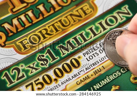 Coquitlam BC Canada - June 02, 2015 : Woman scratching lottery tickets. The British Columbia Lottery Corporation has provided government sanctioned lottery games in British Columbia since 1985.