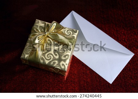 Gift in a golden box and blank envelope