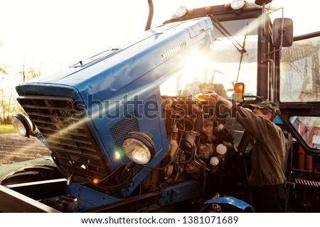 Similar – Image, Stock Photo Farmer repairing detail of agricultural machine
