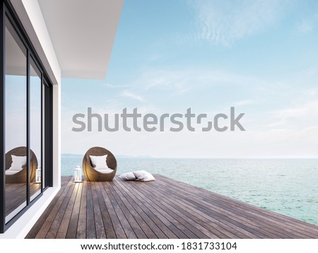 Minimal style room terrace with sea view 3d render,There has dark wooden floors,decorated with rattan furniture and white lantern ,overlooking the sea and sky.