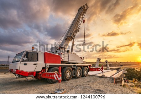 Similar – Image, Stock Photo Boom of a crane in front of colorful evening sky.