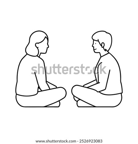 Two people sitting on the floor beside each other