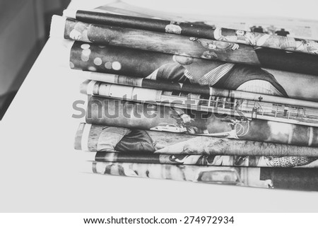 Stack of newspapers, edited in black and white