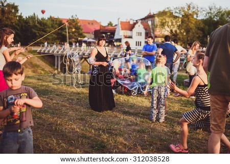 KAUNAS, LITHUANIA - AUGUST 31: BURBULIATORIUS (Bubble your city). A regular public event in Lithuania and other countries. People blowing bubbles on August 31, 2015, Kaunas, Lithuania