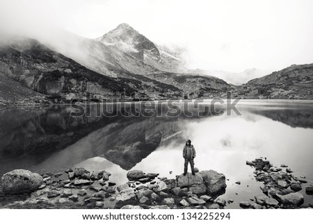 high mountain black and white landscape with hiker and lake