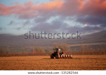 Red sunset over the cultivated farmlands- HDR agricultural background