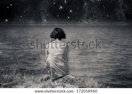 black and white abstract background with women watch beautiful sky over the ocean- elements of this image furnished by NASA