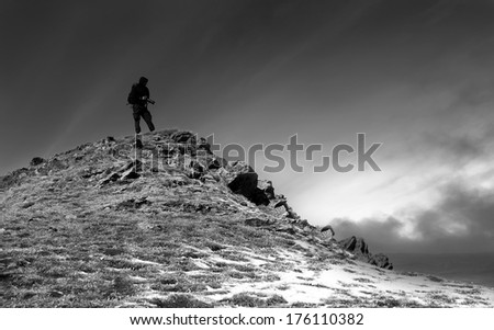 black and white landscape with one photographer on the top in winter mountain