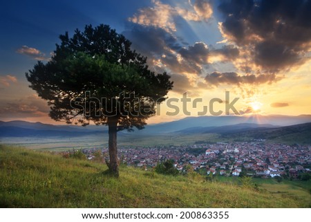 stunning HDR sunset over the small valley with village in bulgarian Rodope mountain