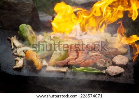 flamed hot bbq on stone plate, hand made camp meet food