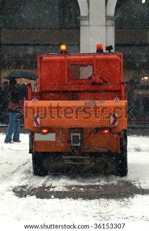 a municipal car for sprinkle half the salt and sand on roads with snow