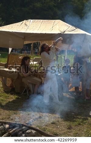 BRESCIA , ITALY - JULY 13: An unidentified man plays an ancient Celtic horn at Celtic Day celebration July 13, 2008 in Brescia, Italy