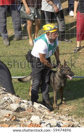 OSPITALETTO, ITALY - AUGUST 21:  World Championship rescue dogs, a dog and its handler for the italian team to a test for the surface,August 21,2010 in Ospitaletto,Italy