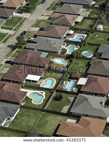 Aerial of typical U.S. middle-class suburb with backyard pools