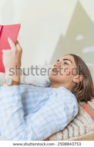 Similar – Image, Stock Photo Thoughtful woman reading book in living room