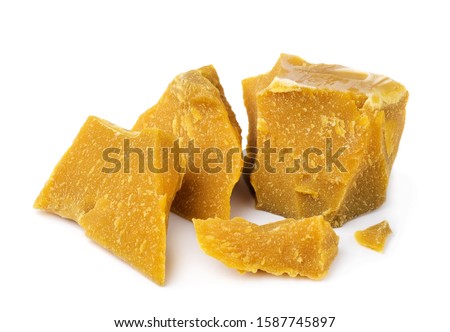 Pieces of organic beeswax on a white background. The use of beeswax in apitherapy. Production Ingredient for Medical and Cosmetics