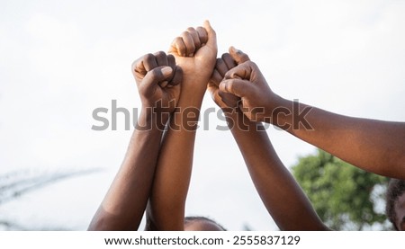 Similar – Image, Stock Photo black fist in the air as a sign of power