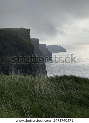 Similar – Image, Stock Photo Majestic cliffs of ocean coastline in sunset