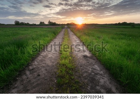 Similar – Foto Bild Ländlicher Feldweg durch frühlingsgrüne Felder. Ländliche Abendszene