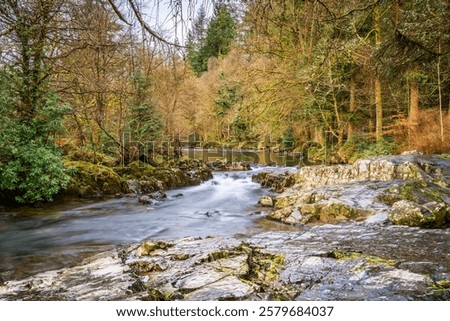 Similar – Foto Bild Schneller Wasserfall, der unter dem Sternenhimmel in der Abenddämmerung durch Felsen fließt