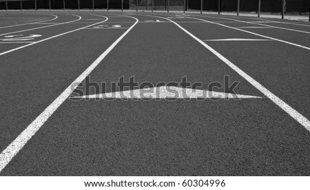Black and white low point of view of cross country track showing lanes and markers.