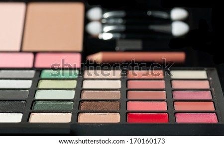 Make-up colorful eyeshadow palettes isolated on black background