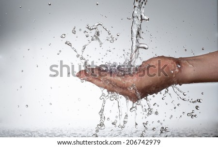 Hands and stream of water. On white background. High resolution.
