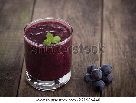 Glass of Grape Juice smoothie on wooden background