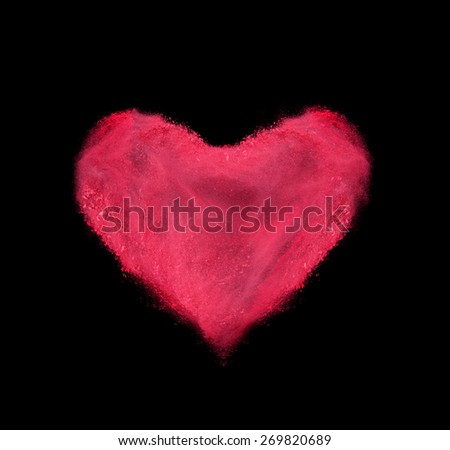 heart made of red powder explosion isolated on black background